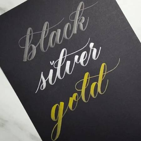Try metallic brush lettering on black paper for shimmering results